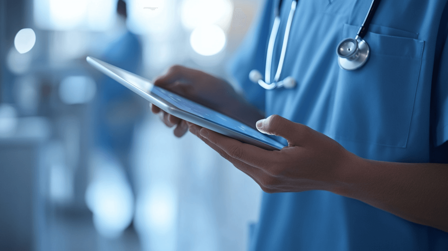 Close-up of a clinician's hands using a tablet.